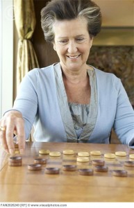 Senior woman playing checkers