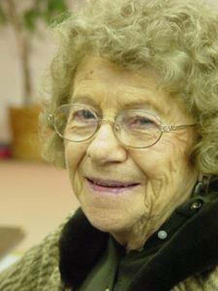 Happy elderly lady at a community dinner