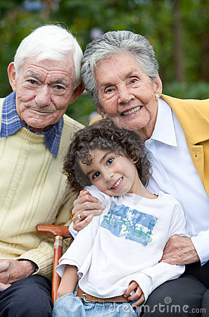 Portrait of a child with his grandparents outdoors
