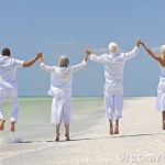 Seniors and family having fun on the beach